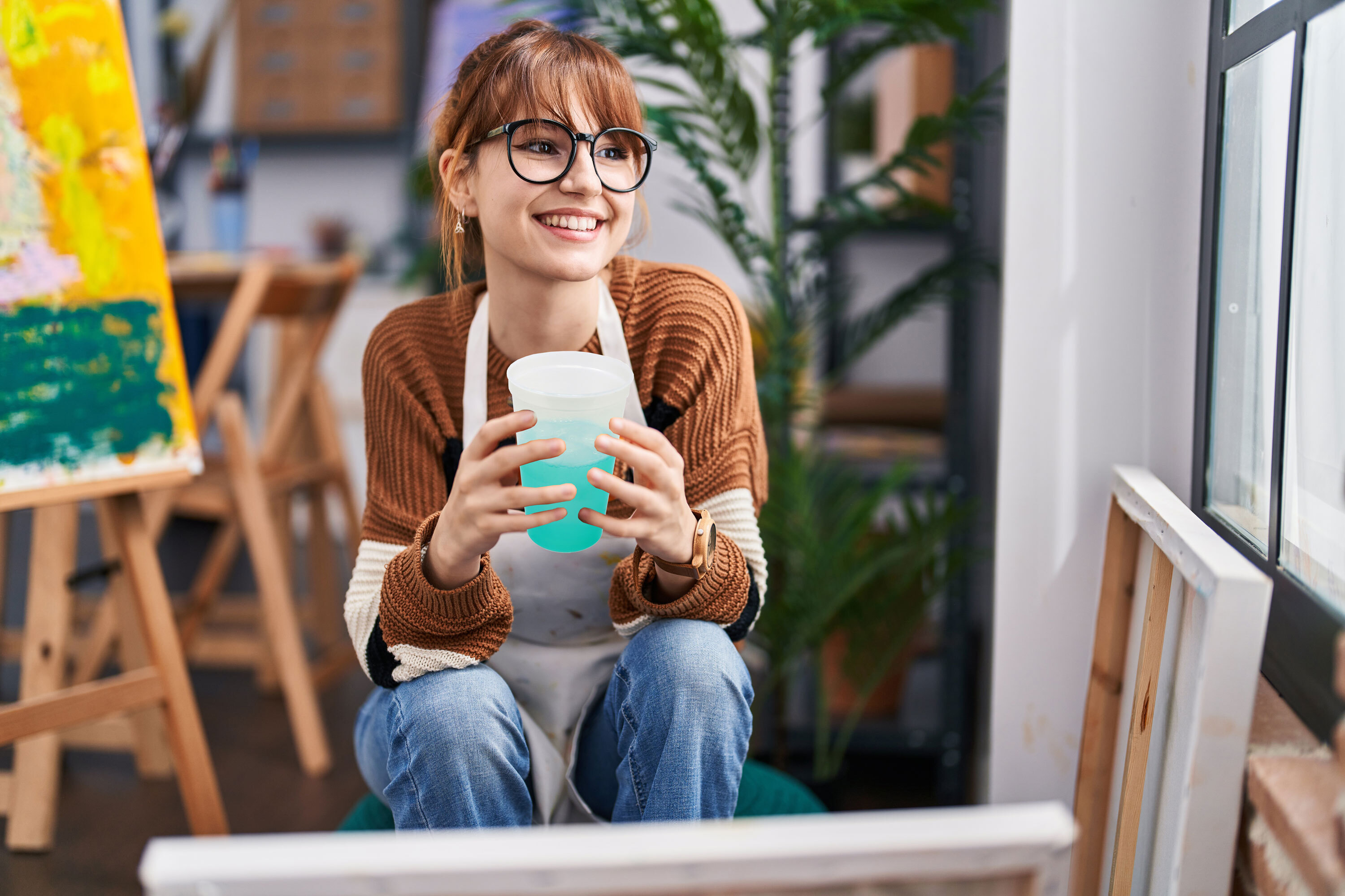 Art teacher holding a color-changing cup on break